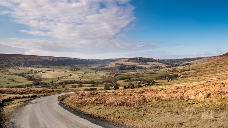 View of a road winding through a hilly landscape